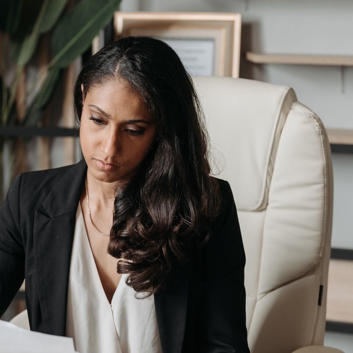 Professional reviewing printed documents at her desk