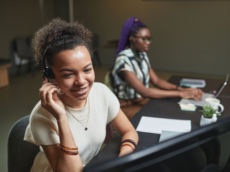 Customer service professional speaking with a caller through a headset